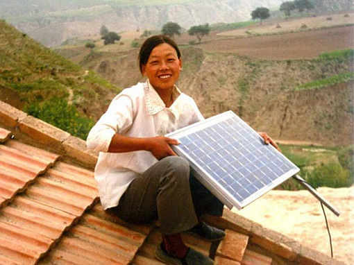 A Chinese Woman Holds Up a Solar Panel