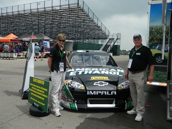 Pam and Garry pose with Kenny Wallace's American Ethanol Car
