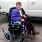smiling girl in loaner power wheelchair