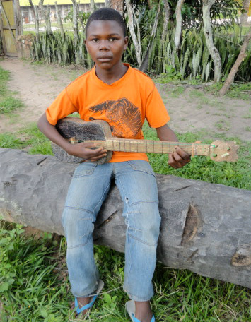 Young Decision holding guitar in Congo