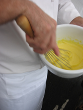whisking yellow substance for cooking demo