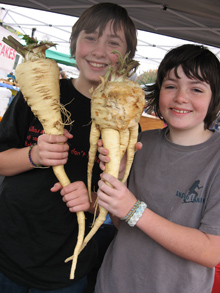 kids showing of giant parsnips