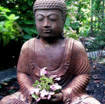 Seated Buddha statue with flowers