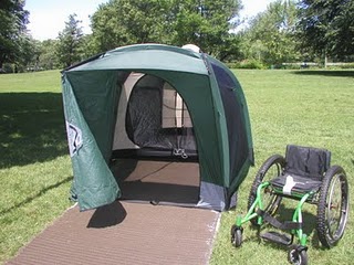 Wheelchair accessible tent with access mat and wheelchair