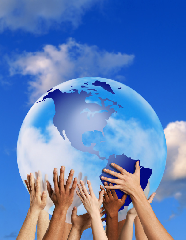 Image of hands holding up a globe. 