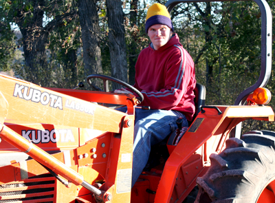 Nolan Miller drives tractor