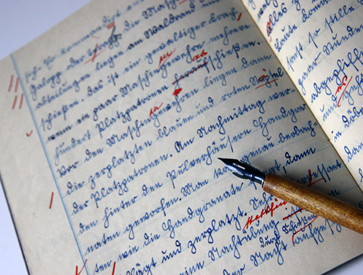 photo of writing in a notebook using a fountain pen