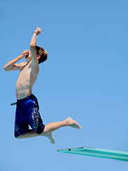 Photo of boy jumping off diving board