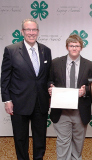 Nate Seese receive award from National 4-H Council