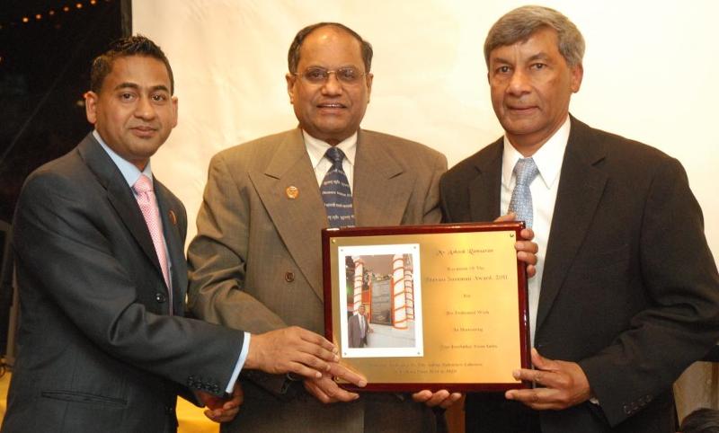 Nohar Singh and Dr. Abraham present special recognition to Ashook Ramsaran