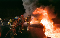 Steven Heicklen, a volunteer fireman, leads his team against a blaze
