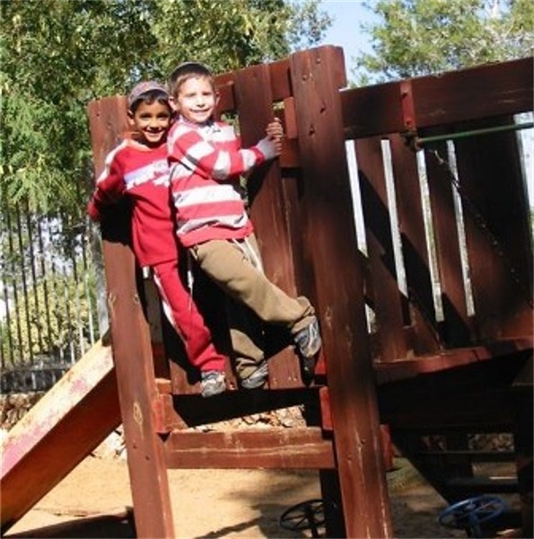 two boys playing on playground equipment