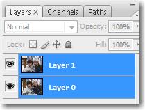 Adobe Phtoshop: Select both layers by clicking on one and then Shift+clicking the other