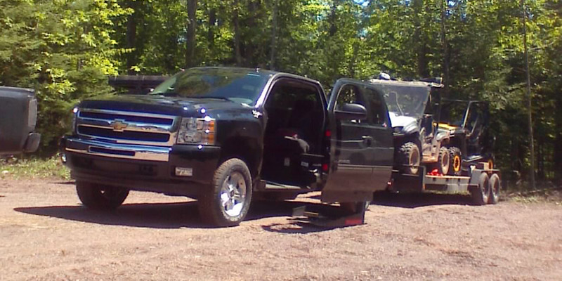 Chevy Silverado with wheelchair accessible conversion towing trailers.