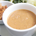 Peanut sauce in a white bowl.