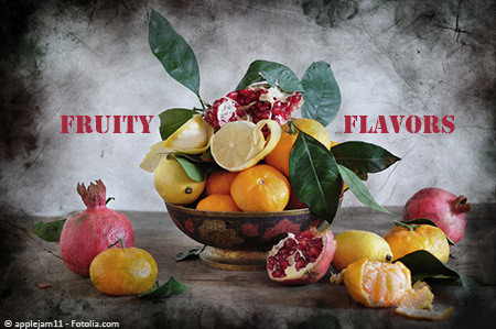 Fruit bowl filled with oranges, lemons, and pomegranates, decorated with citrus leaves. Whole and partially opened fruits are on the table beside the bowl. Text says, 