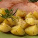 Roasted potatoes garnished with fresh rosemary.