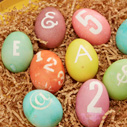 Dyed Easter eggs with numbers and letters on them.