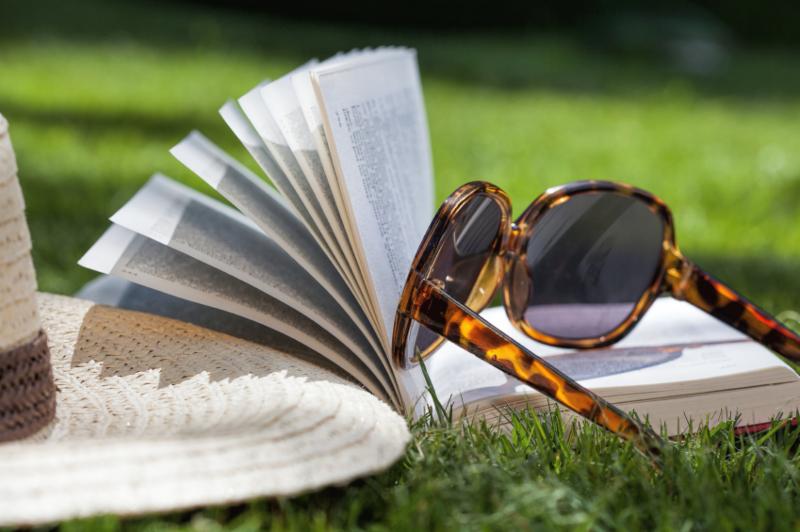Books on grass with sunglasses