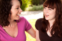 Two girls having a conversation and smiling