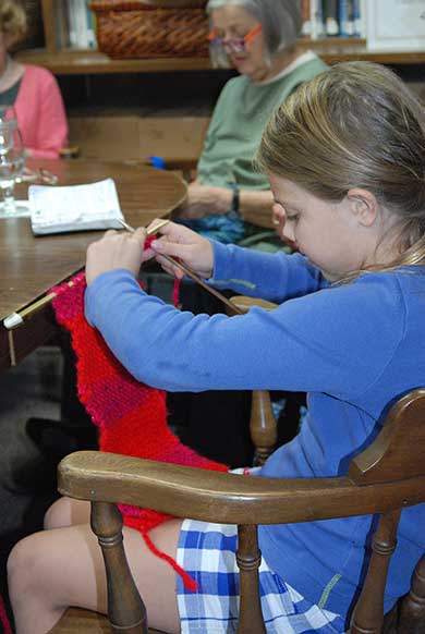 Young girl knitting