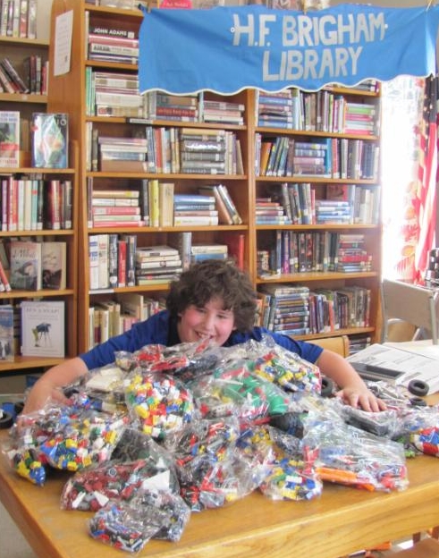 kid with pile of legos
