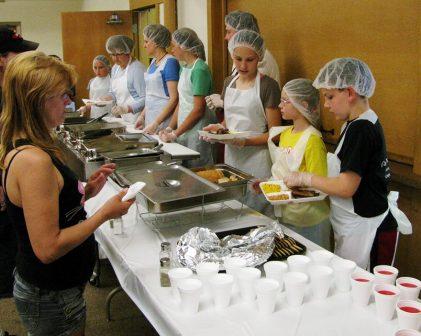 The Wattles Park Trailblazers serving food at a local soup kitchen.