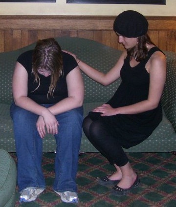 One young person consoling another young person