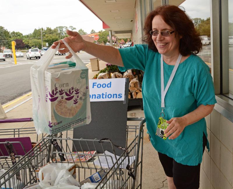 A  volunteer accepts a food donation for the ACCA Food Pantry during last year's Day to Serve. 