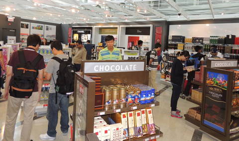 Shoppers browse luxury goods at O'Hare's new duty-free store in the International Terminal.