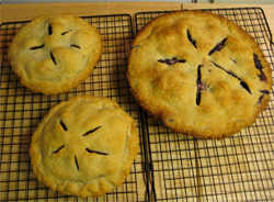 two mini pies and one big blackberry pie