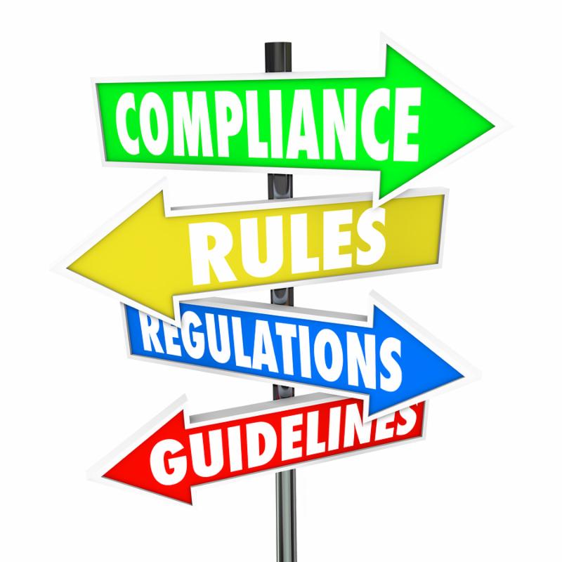The words Compliance, Rules, Regulations and Guidelines on colorful arrow road signs directing you to comply wih important laws or standards