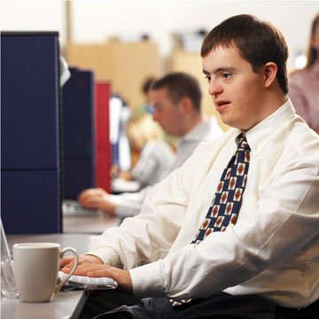 Man with Down Syndrome working at a computer