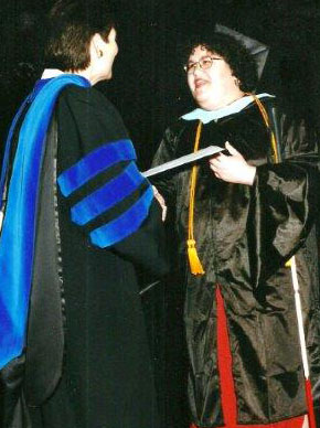 Johnna accepts her diploma at graduation