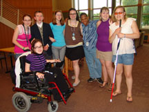 Youth with various disabilities hang out and pose for photo with their arms around each other