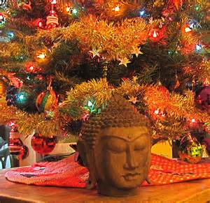 lit up tree with Buddha statue in front