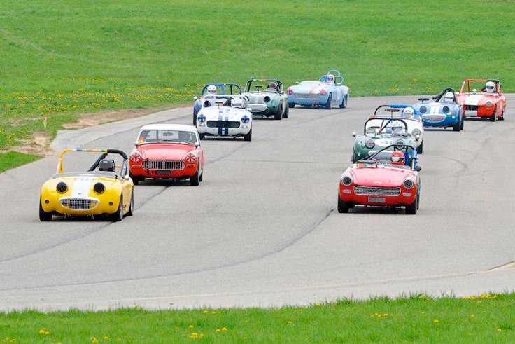    The Spridget pace lap as the drivers head into Turn 1 at Gingerman Raceway for their May launch (photo: Roger Heil)