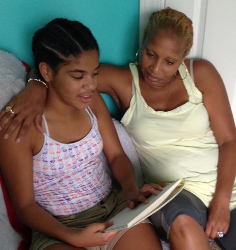 Photo of Anah reading with her grandmother